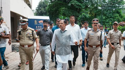 Karnataka Home Minister G Parameshwara with Bengaluru City Commissioner of Police B Dayananda and other police personnel during an inspection after the stampede near the Chinnaswamy stadium. (PTI) Karnataka Home Minister G Parameshwara with Bengaluru City Commissioner of Police B Dayananda and other police personnel during an inspection after the stampede near the Chinnaswamy stadium. (PTI)