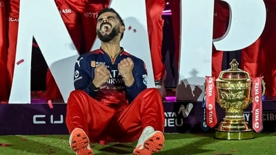 Royal Challengers Bengaluru's Virat Kohli reacts while sitting beside the trophy after winning the Indian Premier League (IPL) Twenty20 final cricket match against Punjab Kings (AFP) Royal Challengers Bengaluru's Virat Kohli reacts while sitting beside the trophy after winning the Indian Premier League (IPL) Twenty20 final cricket match against Punjab Kings (AFP)