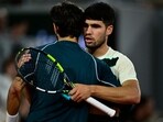 Spain's Carlos Alcaraz (R) embraces Italy's Lorenzo Musetti after the latter withdrew due to an injury in their men's singles French Open semi-final. Spain's Carlos Alcaraz (R) embraces Italy's Lorenzo Musetti after the latter withdrew due to an injury in their men's singles French Open semi-final.