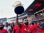 Royal Challengers Bengaluru's Virat Kohli displays the Indian Premier League winners' trophy to the fans at the M. Chinnaswamy Stadium in Bengaluru, India, Wednesday, June 4, 2025. 