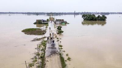 An aerial view of houses along a road partially submerged in floodwater in Morigaon district of Assam on Thursday. (PTI Photo) An aerial view of houses along a road partially submerged in floodwater in Morigaon district of Assam on Thursday. (PTI Photo)