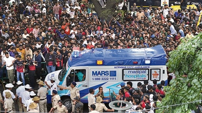 An ambulance arrives at the M Chinnaswamy Stadium as fans gather to celebrate Royal Challengers Bengaluru cricketers, winners of the Indian Premier League, in Bengaluru. (AP) An ambulance arrives at the M Chinnaswamy Stadium as fans gather to celebrate Royal Challengers Bengaluru cricketers, winners of the Indian Premier League, in Bengaluru. (AP)