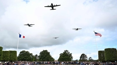 Military aircraft soared over the American Cemetery in Colleville-sur-Mer on June 6, 2025, as part of a memorial ceremony marking the 81st anniversary of the D-Day landings. (Photo by Lou BENOIST / AFP) (AFP) Military aircraft soared over the American Cemetery in Colleville-sur-Mer on June 6, 2025, as part of a memorial ceremony marking the 81st anniversary of the D-Day landings. (Photo by Lou BENOIST / AFP) (AFP)