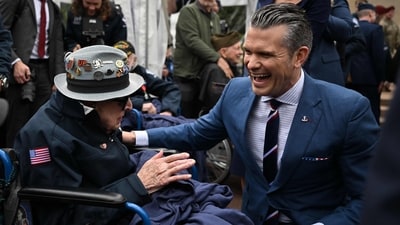 U.S. Secretary of Defense Pete Hegseth shared a heartfelt moment with 102-year-old World War II and D-Day veteran Jake Larson, affectionately known as “Papa Jake,” following a memorial ceremony at the American Cemetery in Colleville-sur-Mer on June 6, 2025. (Photo by Lou BENOIST / AFP) (AFP) U.S. Secretary of Defense Pete Hegseth shared a heartfelt moment with 102-year-old World War II and D-Day veteran Jake Larson, affectionately known as “Papa Jake,” following a memorial ceremony at the American Cemetery in Colleville-sur-Mer on June 6, 2025. (Photo by Lou BENOIST / AFP) (AFP)