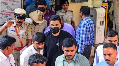 Royal Challengers Bengaluru's (RCB) Head of Marketing and Revenue, Nikhil Sosale (black t-shirt), along with three staff members of DNA Entertainment Networks Private Ltd., being taken to court after their arrest in a stampede incident near the M. Chinnaswamy Stadium, at Cubbon Park Police Station in Bengaluru. (AFP) Royal Challengers Bengaluru's (RCB) Head of Marketing and Revenue, Nikhil Sosale (black t-shirt), along with three staff members of DNA Entertainment Networks Private Ltd., being taken to court after their arrest in a stampede incident near the M. Chinnaswamy Stadium, at Cubbon Park Police Station in Bengaluru. (AFP)