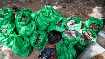 Workers remove footwear lying near Gate No. 7 of the Chinnaswamy Stadium a day after the stampede, following a large gathering of fans for the felicitation of IPL 2025 winning Royal Challengers Bengaluru team (PTI) Workers remove footwear lying near Gate No. 7 of the Chinnaswamy Stadium a day after the stampede, following a large gathering of fans for the felicitation of IPL 2025 winning Royal Challengers Bengaluru team (PTI)