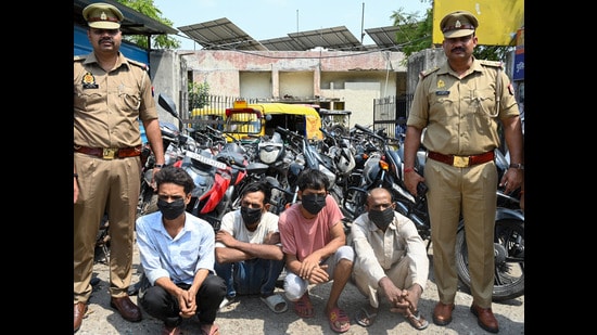 The accused with the vehicles recovered from them. (Sunil Ghosh/HT photo)