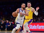 Steph Curry in action for Golden State Warriors against Luka Doncic and the Los Angeles Lakers.