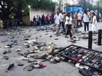Fans stand next to abandoned shoes and a fallen barrier following a stampede during celebrations. Fans stand next to abandoned shoes and a fallen barrier following a stampede during celebrations.