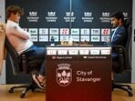 Norway's Magnus Carlsen (L) plays against India's D Gukesh.