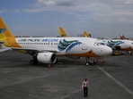 A security guard stands near passenger jets at Terminal 3 of the Ninoy Aquino International aiport in Pasay city, Metro Manila, Philippines.