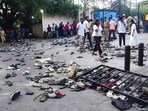 Fans stand next to abandoned shoes and a fallen barrier following a stampede during celebrations, a day after Royal Challengers Bengaluru's victory at the Indian Premier League (IPL) Twenty20 final cricket match, outside the M. Chinnaswamy Stadium in Bengaluru on June 4, 2025.