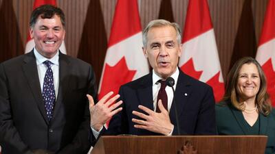 Canada's Prime Minister Mark Carney (C) speaks during a news conference, alongside President of the King’s Privy Council for Canada Dominic LeBlanc (L) and Minister of Transport and Internal Trade Chrystia Freeland (R), during a news conference on Parliament Hill, in Ottawa, on Friday. (AFP) Canada's Prime Minister Mark Carney (C) speaks during a news conference, alongside President of the King’s Privy Council for Canada Dominic LeBlanc (L) and Minister of Transport and Internal Trade Chrystia Freeland (R), during a news conference on Parliament Hill, in Ottawa, on Friday. (AFP)
