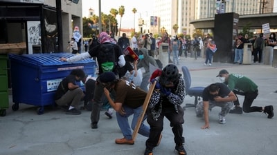 Protesters blocking the garage entrance of the Los Angeles Federal Building react as police fires pepper spray at them following multiple detentions by ICE in Los Angeles (Reuters) Protesters blocking the garage entrance of the Los Angeles Federal Building react as police fires pepper spray at them following multiple detentions by ICE in Los Angeles (Reuters)