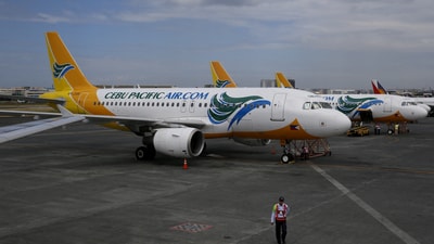 A security guard stands near passenger jets at Terminal 3 of the Ninoy Aquino International aiport in Pasay city, Metro Manila, Philippines. (REUTERS)