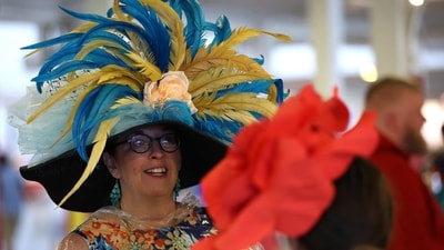 A fan, sporting a stunning feathered hat, looked on with anticipation between races at Saratoga Race Course on June 7, 2025, ahead of the 157th running of the Belmont Stakes. (Photo by AL BELLO / GETTY IMAGES NORTH AMERICA / Getty Images via AFP) (Getty Images via AFP) A fan, sporting a stunning feathered hat, looked on with anticipation between races at Saratoga Race Course on June 7, 2025, ahead of the 157th running of the Belmont Stakes. (Photo by AL BELLO / GETTY IMAGES NORTH AMERICA / Getty Images via AFP) (Getty Images via AFP)