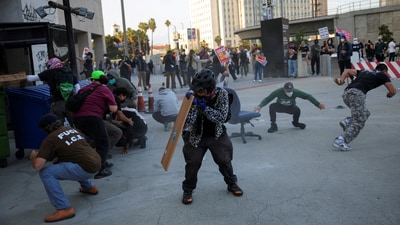 Protesters blocking the garage entrance of the Los Angeles Federal Building reacted as police fired pepper spray at them following several detentions by ICE in downtown Los Angeles. On Friday evening, dozens gathered outside a federal detention center in Los Angeles, chanting “set them free, let them stay!” believing those arrested were held there. (REUTERS)