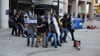 Police detained a protester blocking the garage entrance of the Los Angeles Federal Building after multiple arrests by ICE in downtown Los Angeles on Friday. (REUTERS)