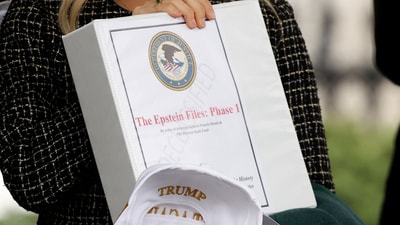 In February some Conservative political commentators were spotted at the White House holding binders that read “The Epstein Files.” (REUTERS/Kevin Lamarque)