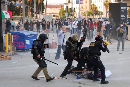 Police detains a protester blocking the garage entrance of the Los Angeles Federal Building following multiple detentions by Immigration and Customs Enforcement (ICE). (REUTERS)