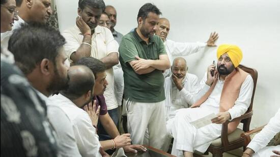 Punjab chief minister Bhagwant Mann with people protesting the police inaction in probing the Samana road accident on Saturday. (HT Photo)