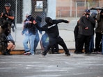 A protester throws a firework during a standoff between police and protesters following multiple detentions by Immigration and Customs Enforcement (ICE), in the Los Angeles County city of Paramount, California, U.S., June 7, 2025.  