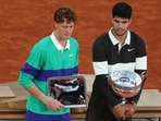 Winner Spain's Carlos Alcaraz (R) and finalist Italy's Jannik Sinner pose with their respective trophies. Winner Spain's Carlos Alcaraz (R) and finalist Italy's Jannik Sinner pose with their respective trophies.