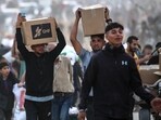 People carry relief supplies from the Gaza Humanitarian Foundation (GHF), a private US-backed aid group that has bypassed the longstanding UN-led system in the territory People carry relief supplies from the Gaza Humanitarian Foundation (GHF), a private US-backed aid group that has bypassed the longstanding UN-led system in the territory