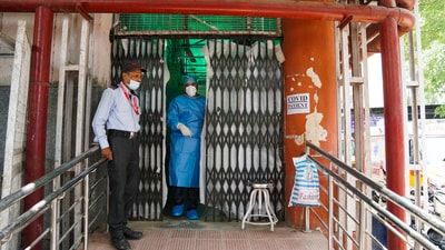 A security official stands guard outside a ward set up for Covid-19 patients amid an uptick in cases in Delhi. (PTI) A security official stands guard outside a ward set up for Covid-19 patients amid an uptick in cases in Delhi. (PTI)