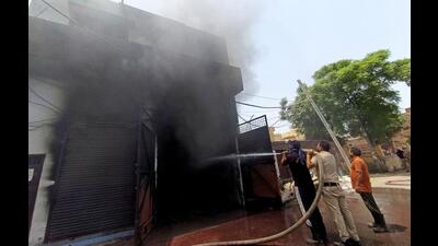 Firefighter dousing flames at the paint factory in the Anngarh area, Amritsar, on Sunday. (Sameer Sehgal/HT)