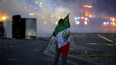 Governor Newsom urged peaceful protest, warning, “Federal authorities want a spectacle. Don’t give them one.” In pic: A protester holds a Mexican flag during a standoff between police and protesters following multiple detentions by Immigration and Customs Enforcement (ICE), in the Los Angeles County city of Compton. (REUTERS)