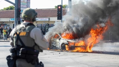 A car burns as law enforcement clashes with demonstrators during a protest following federal immigration operations, in the Compton neighborhood of Los Angeles, California on June 7, 2025. (AFP) A car burns as law enforcement clashes with demonstrators during a protest following federal immigration operations, in the Compton neighborhood of Los Angeles, California on June 7, 2025. (AFP)