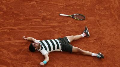 Spain's Carlos Alcaraz celebrates after defending the men's singles title by beating Italy's Jannik Sinner in the final at Roland Garros on Sunday. (REUTERS)
