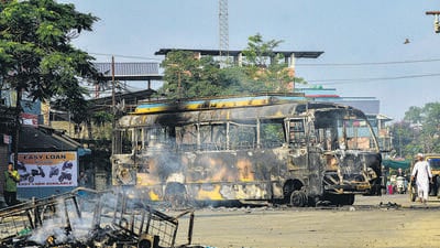 The charred remains of a bus used for transporting central forces that was set on fire during protests over the arrest of a leader of Meitei outfit Arambai Tenggol in Imphal East district. (PTI) The charred remains of a bus used for transporting central forces that was set on fire during protests over the arrest of a leader of Meitei outfit Arambai Tenggol in Imphal East district. (PTI)