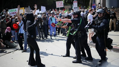 Los Angeles Metro Police and demonstrators confront each other during a protest against federal immigration sweeps in downtown Los Angeles, California, US on June 8, 2025. (REUTERS)