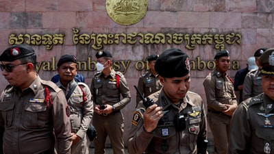 Police officers stand guard in front of the Royal Embassy of Cambodia during a protest by royalist activists, following a recent clash at the Thailand-Cambodia border. (REUTERS)