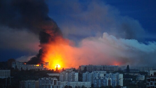 Fire and smoke rise from the site where a Russian missile struck a residential area in Kharkiv, Ukraine (AP)