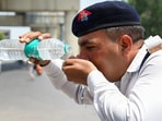 As the temperature in Delhi-NCR rises, traffic police personnel drink water in the heat. As the temperature in Delhi-NCR rises, traffic police personnel drink water in the heat.