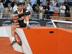 Spain's Carlos Alcaraz poses with the trophy after winning the final match of the French Tennis Open against Italy's Jannik Sinner at the Roland-Garros stadium
