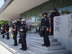 Police stand guard near the metropolitan detention center Monday. Police stand guard near the metropolitan detention center Monday.