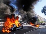 Two Waymo taxis burn near the metropolitan detention center of downtown Los Angeles, Sunday, June 8, 2025, following last night's immigration raid protest. Two Waymo taxis burn near the metropolitan detention center of downtown Los Angeles, Sunday, June 8, 2025, following last night's immigration raid protest.