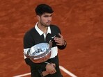 Spain's Carlos Alcaraz poses with his trophy after his victory in the men's singles final match against Italy's Jannik Sinner