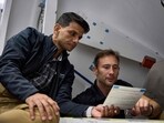 This handout photograph taken on September 6, 2024 and released by private aerospace company Axiom Space shows assigned Ax-4 crew members Shubhanshu Shukla (L) and Slawosz Uznanski reviewing a procedure checklist. This handout photograph taken on September 6, 2024 and released by private aerospace company Axiom Space shows assigned Ax-4 crew members Shubhanshu Shukla (L) and Slawosz Uznanski reviewing a procedure checklist.