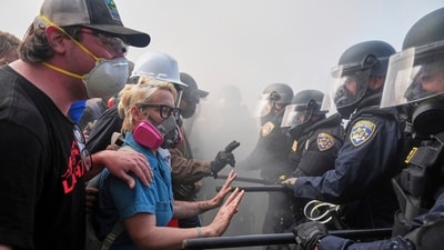 Authorities arrested about 30 people on Saturday, including three suspected of assaulting an officer. Three deputies sustained minor injuries. The FBI offered a $50,000 reward for information on a suspect who threw rocks at police vehicles in Paramount, injuring a federal officer. (REUTERS)