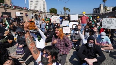 Protesters block the 101 Freeway near the Metropolitan Detention Center following immigration raid protests. Police declared one rally near City Hall an "unlawful assembly," citing protesters throwing concrete, bottles, and other objects. (AP)