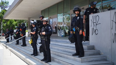 Police stand guard near the metropolitan detention center Monday. (AP)