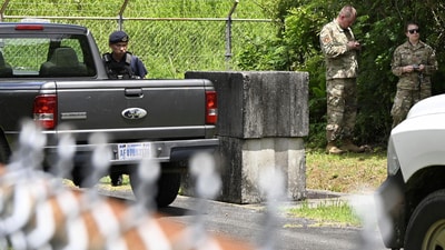 US military personnel gather near the site of an explosion at a storage site for unexploded ordnances in Okinawa. (AP) US military personnel gather near the site of an explosion at a storage site for unexploded ordnances in Okinawa. (AP)