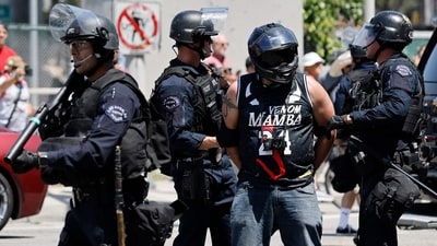 A protestor is arrested by LAPD officers on June 08, 2025 in Los Angeles, California. (Getty Images via AFP) A protestor is arrested by LAPD officers on June 08, 2025 in Los Angeles, California. (Getty Images via AFP)