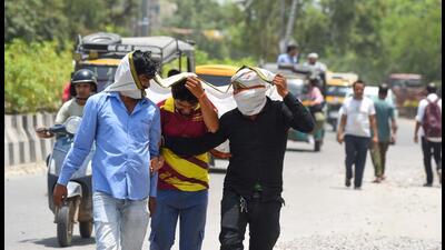 People seen covering their heads and faces to protect themselves on a hot summer day in Gurugram on Monday. (Parveen Kumar/Hindustan Times) People seen covering their heads and faces to protect themselves on a hot summer day in Gurugram on Monday. (Parveen Kumar/Hindustan Times)