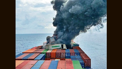 Smoke billows from the Singapore-flagged container ship on Monday. (ANI) Smoke billows from the Singapore-flagged container ship on Monday. (ANI)